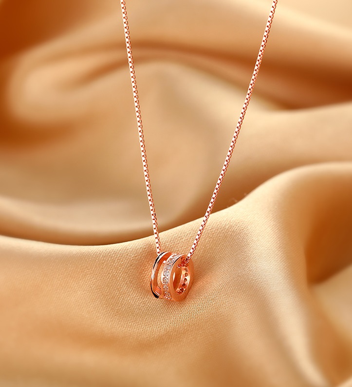 A close-up of the 925 Sterling Silver Rose Gold Plated Geometric Round Circle Necklace, showcasing its delicate pendant and sparkling cubic zirconia.