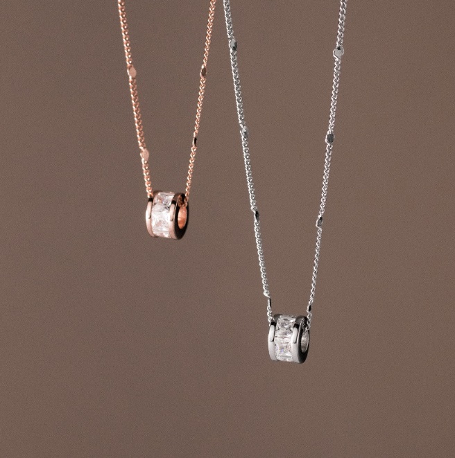 A pair of 925 Sterling Silver Baguette CZ Necklaces, one in a polished silver finish and the other in a warm rose gold finish, displayed side-by-side.
