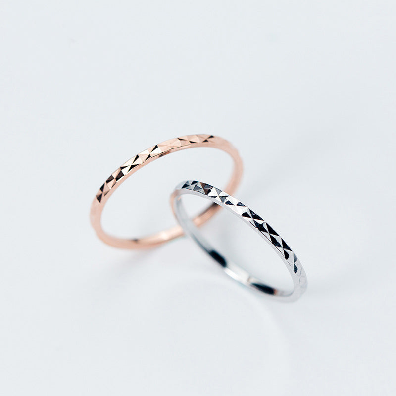 A close-up of the 925 Sterling Silver Line Stack Ring Set, showing the detailed texture on both the silver and rose gold finished rings.