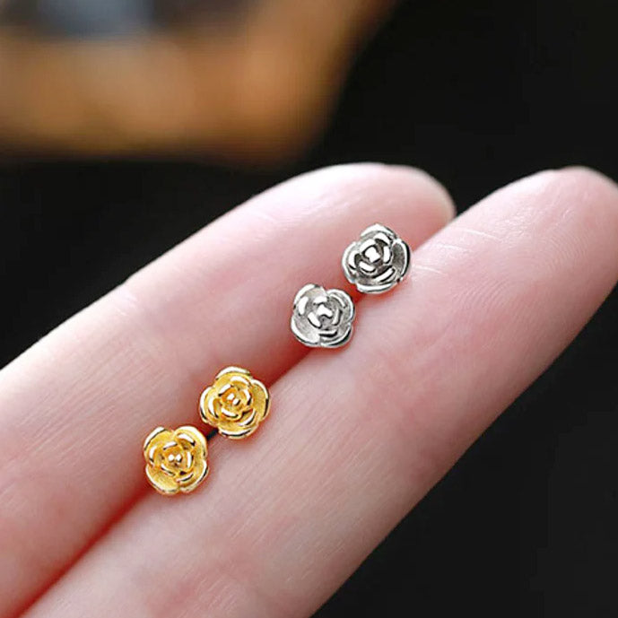 A pair of 925 sterling silver dainty flower rose stud earrings shown in both gold and silver finishes, highlighting the intricate petal details.