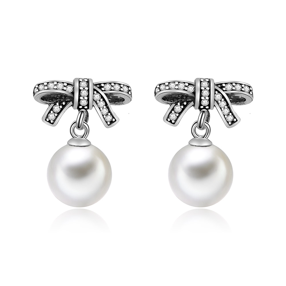 Elegant 925 sterling silver bow stud earrings with a dangling white shell pearl and cubic zirconia.