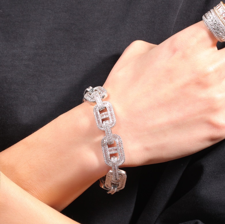 A stylish silver hip hop luxury bracelet with matching rings displayed on a black background, offered by JR Fashion Accessories.