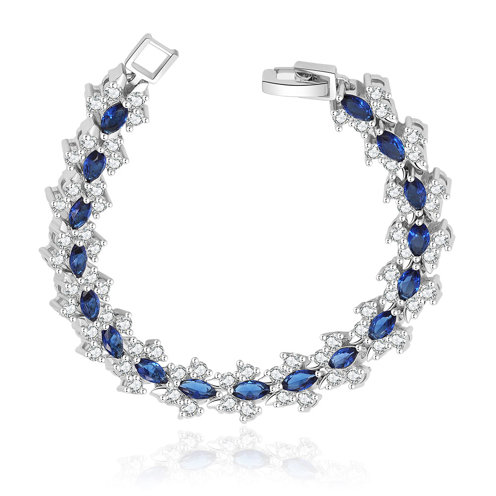 Close-up of the Tennis Montana Tear Bracelet, showcasing the intricate setting of blue Montana glass and clear AAA+ Cubic Zirconia on a rhodium-plated brass band.