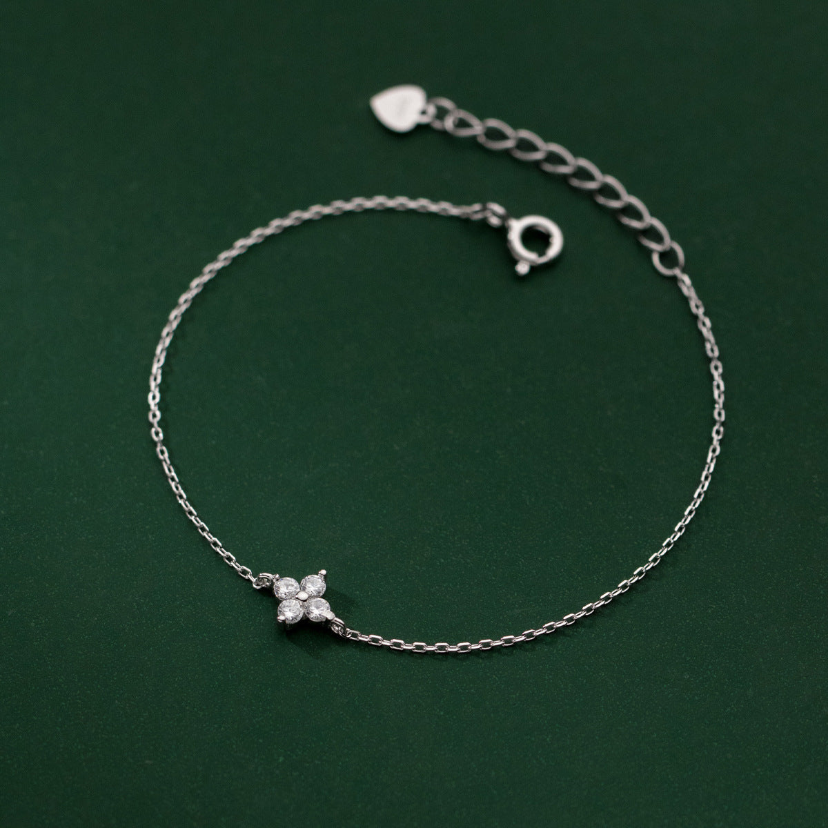 A close-up of the 925 sterling silver four-leaf clover flower charm bracelet, showcasing the delicate chain and lucky clover design.