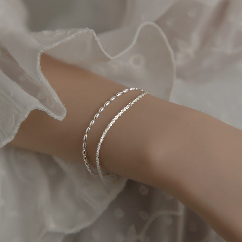 A set of five 925 sterling silver bracelets with crystal beads and varied chain designs, displayed on a neutral background for JR Fashion Accessories.