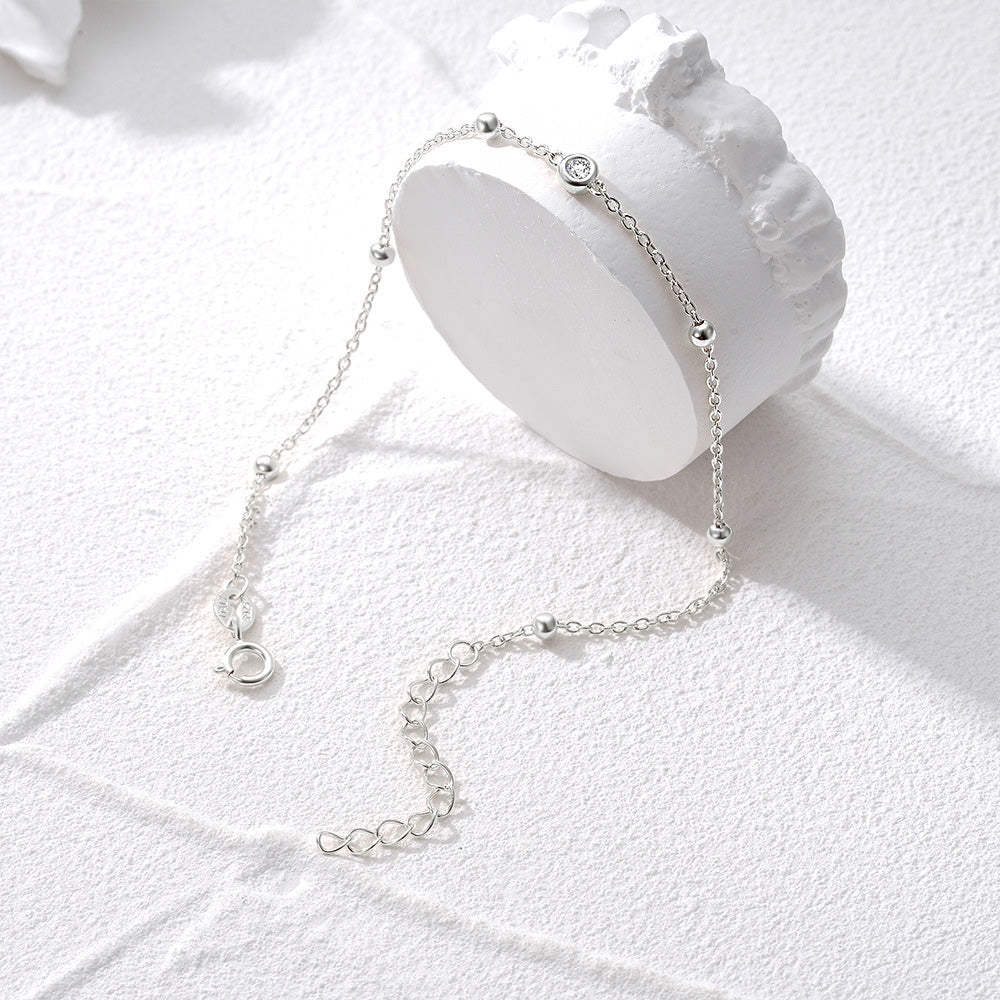A minimalist 925 sterling silver bead chain bracelet with a circular charm, part of a set of five, on a clean white background.
