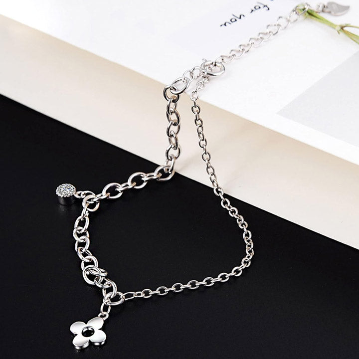 A detailed studio shot of the 925 Sterling Silver Four-Leaf Clover Charm Bracelet, showcasing the polished silver chain and the lucky clover charm.