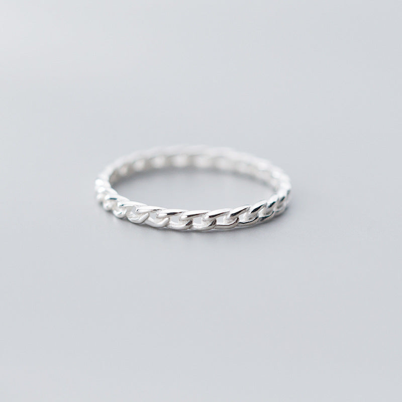 A close-up of a 925 sterling silver ring with a simple, elegant chain-link design, part of a versatile set of five.