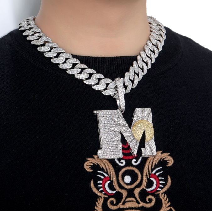 A model wearing a custom letters hip hop necklace with a large silver 'M' pendant, showcasing the bold style.