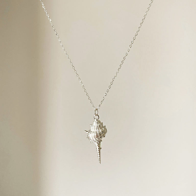 A detailed studio shot of the S925 Sterling Silver Sea Beach Conch Shell Pendant Necklace, highlighting the intricate design of the silver shell.