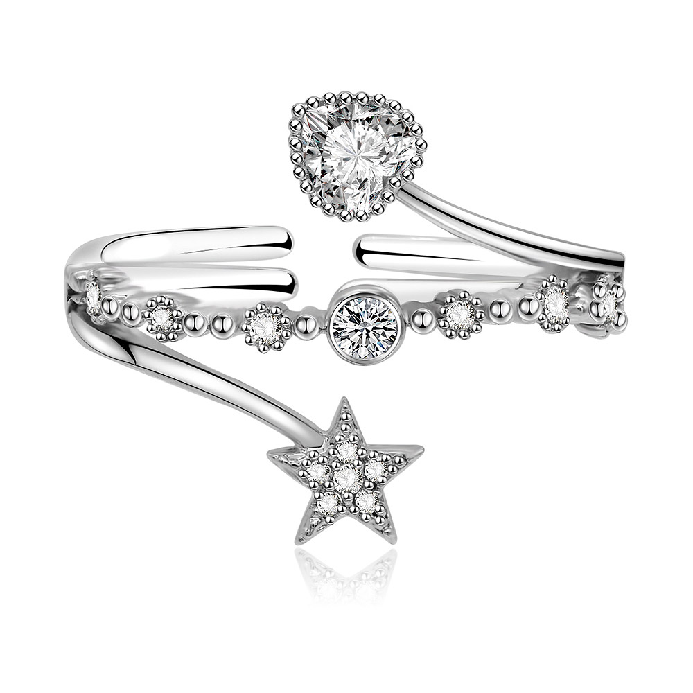 A close-up of the Star Heart Band Ring, showcasing the rhodium-plated brass band with a star charm and sparkling cubic zirconia gemstones.