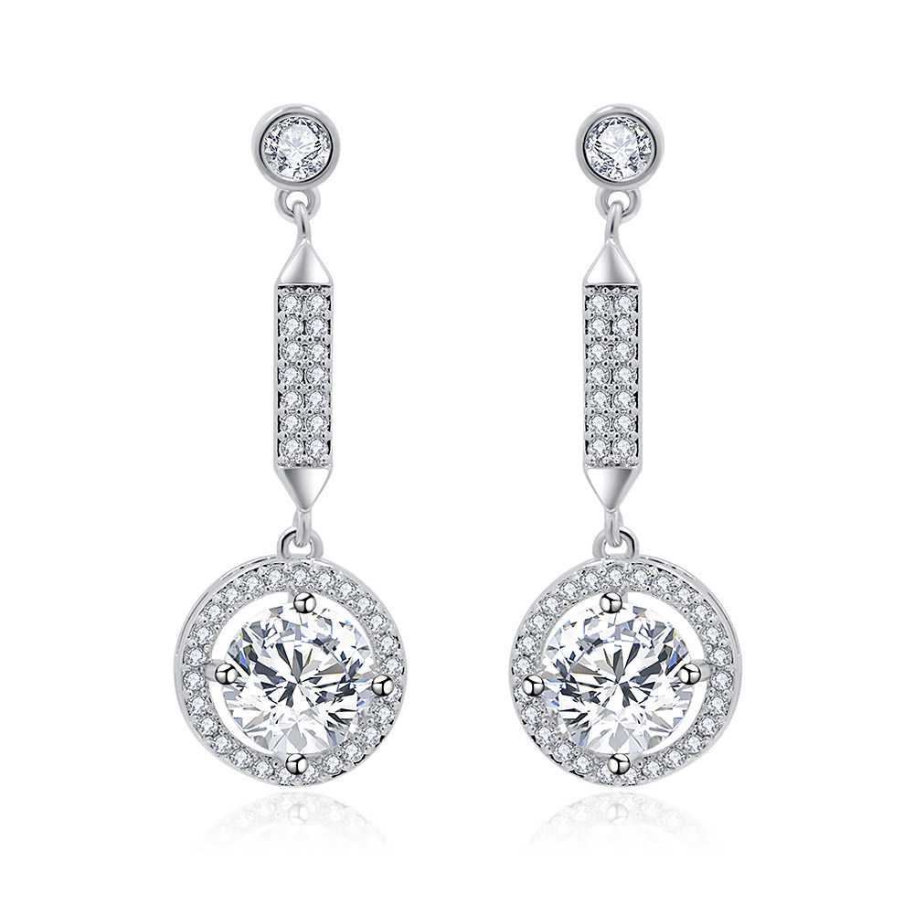 A pair of Twilight Sparkling CZ Halo Round Earrings, showcasing their silver dangle design with a large circular cubic zirconia pendant.