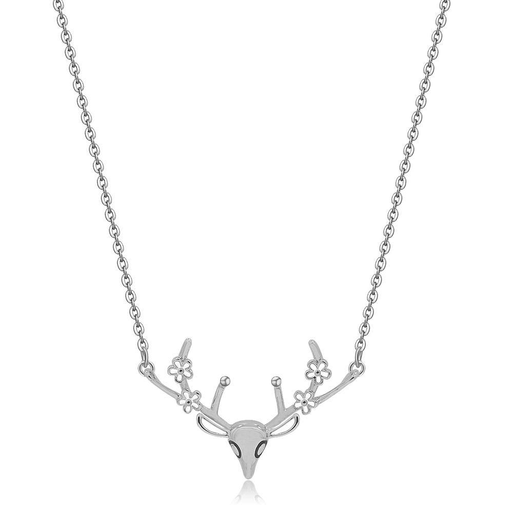 Close-up of the delicate deer antler necklace, showcasing the silver deer head pendant with intricate floral details on the antlers and sparkling cubic zirconia.
