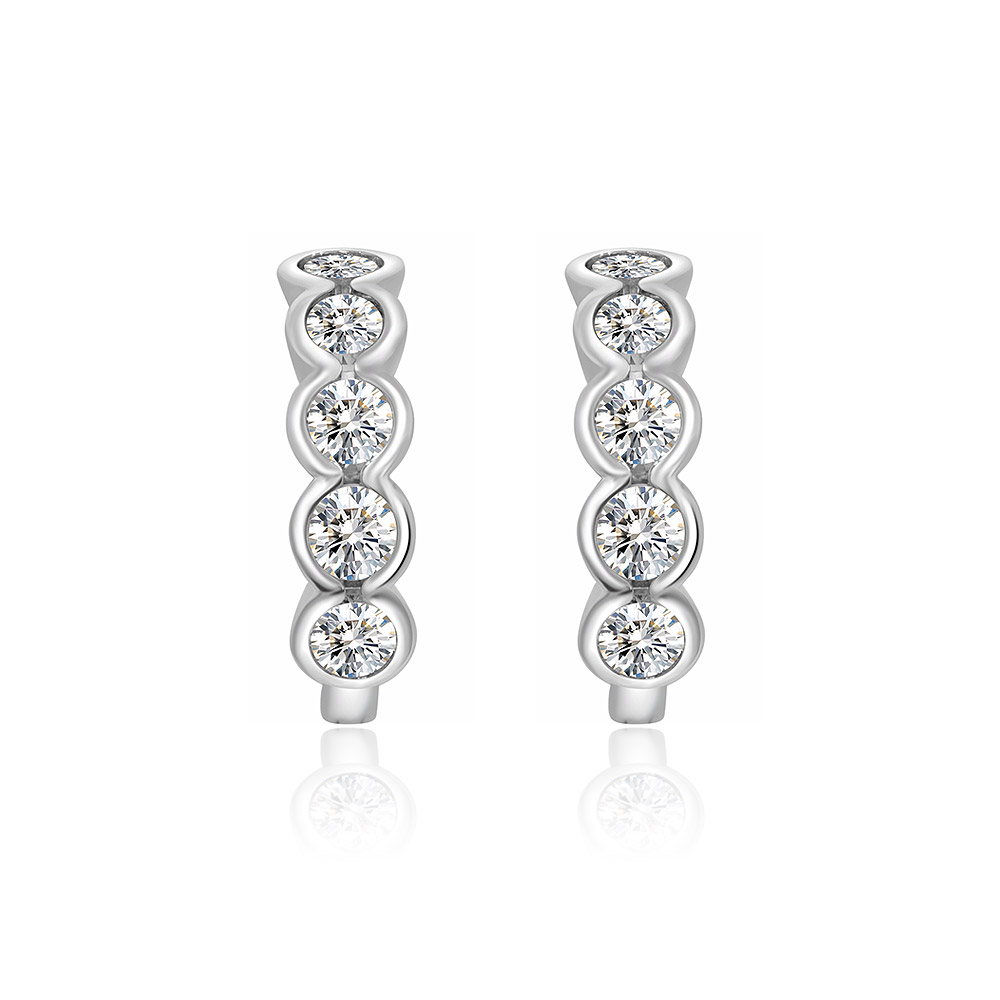 A pair of rhodium-plated brass mini huggie earrings, each featuring four brilliant, bezel-set cubic zirconia stones against a white background.