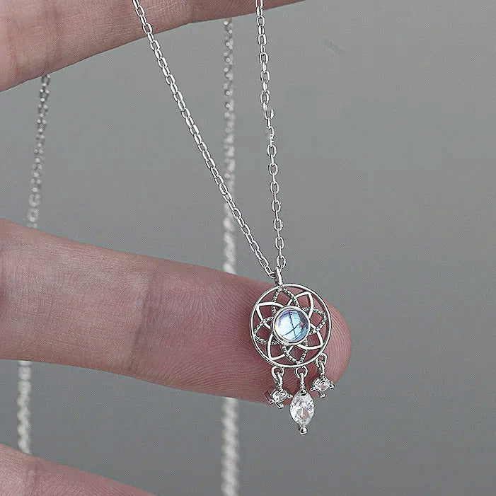 A 925 sterling silver necklace featuring an elegant dreamcatcher pendant with a central moonlight stone, displayed on a white background.