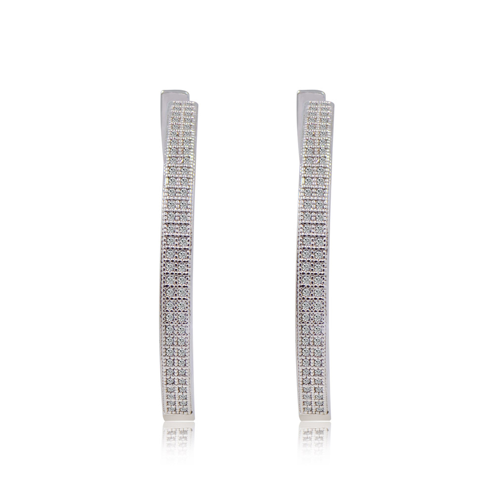 A pair of large CZ hoop earrings made of rhodium-plated brass, showcasing clear cubic zirconia gemstones on a white background.