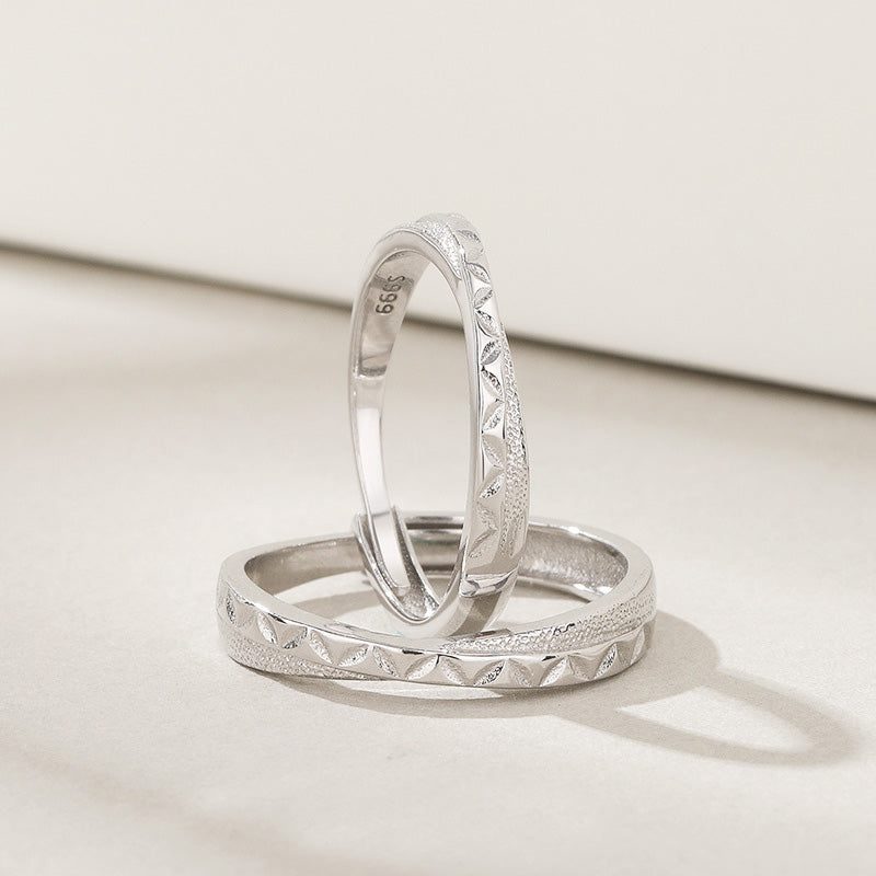 A pair of intricately etched 925 sterling silver couple rings, symbolizing love and commitment, perfect for Valentine's Day.