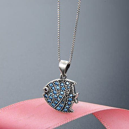 A detailed 925 sterling silver tropical fish pendant necklace adorned with sparkling blue and clear stones, part of a delightful five-piece set.