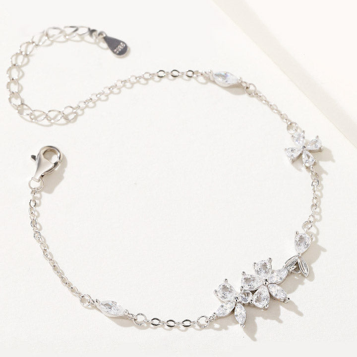A close-up of a 925 sterling silver sakura flower bracelet from the set, showcasing the intricate floral design with sparkling clear zircon stones.
