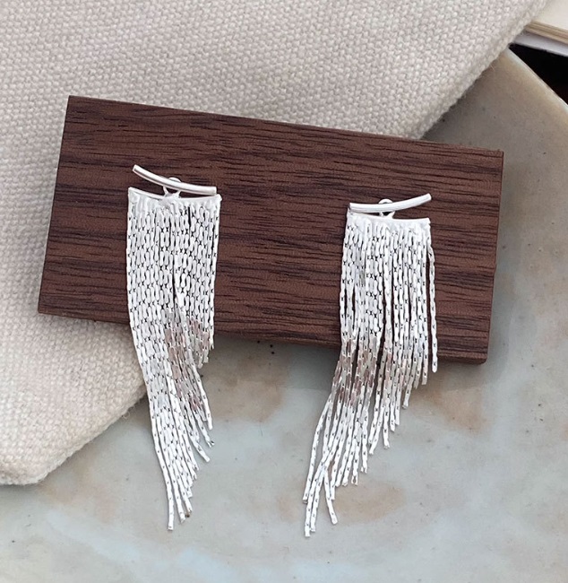 A pair of 925 Sterling Silver Tassel Dangle Earrings (JRS-021610) displayed on a wooden stand, showcasing their intricate fringe design.