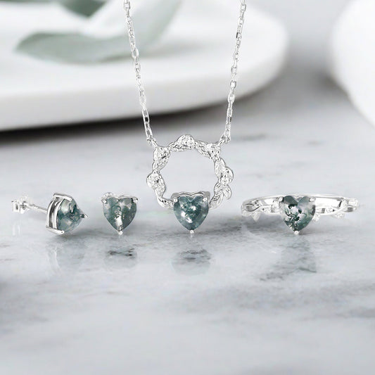 A stunning heart-themed jewelry set by JR Fashion Accessories, featuring a sterling silver necklace, ring, and earrings with heart-shaped stones, perfect for wholesale collections.