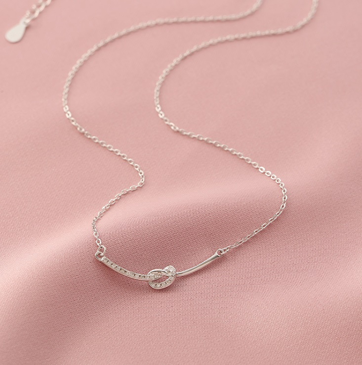 A close-up of the 925 Sterling Silver Smile Necklace, showcasing its delicate heart-shaped pendant with a sparkling cubic zirconia stone.
