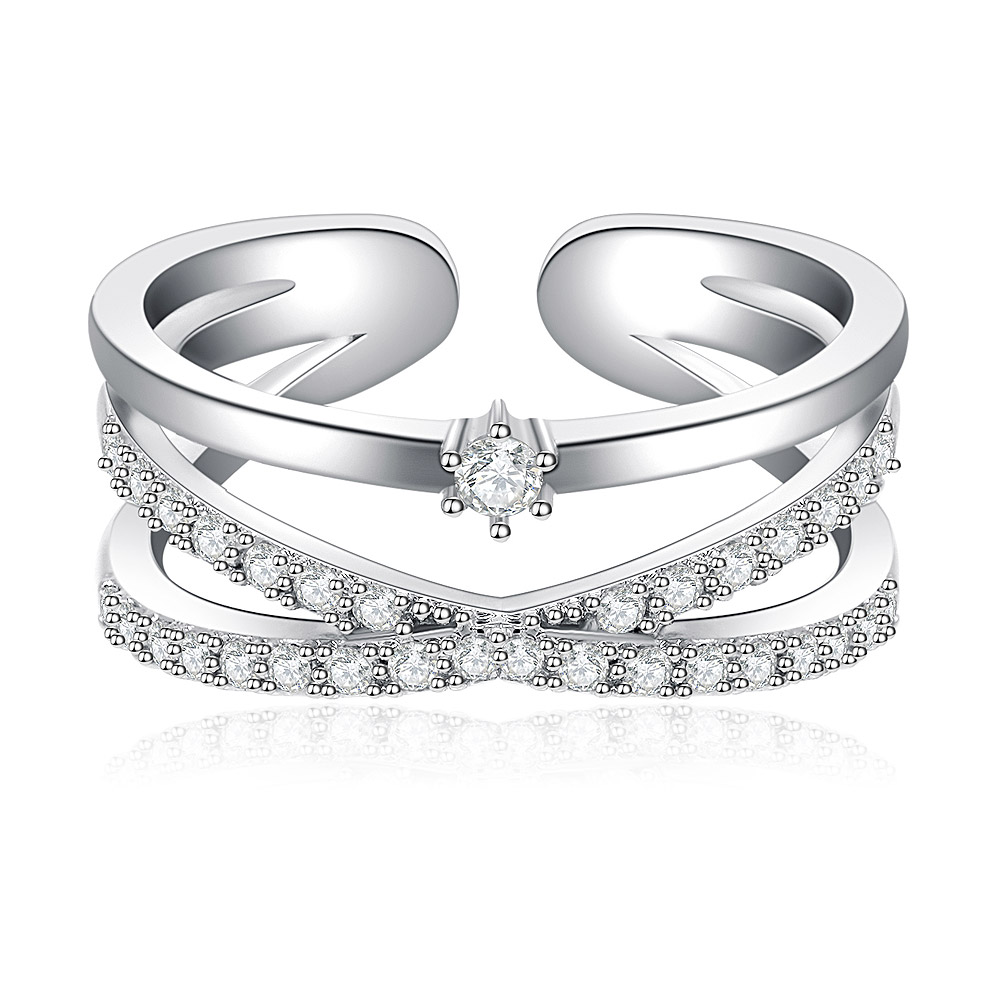 A stylish rhodium-plated brass ring featuring a criss-cross design studded with clear cubic zirconia stones.
