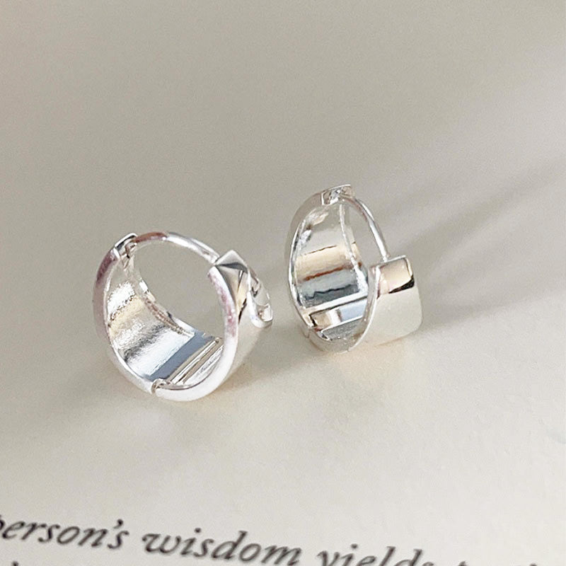 A clear product shot of the 925 Sterling Silver Small Polished Wide Hoop Earrings, showcasing their classic design and polished finish.