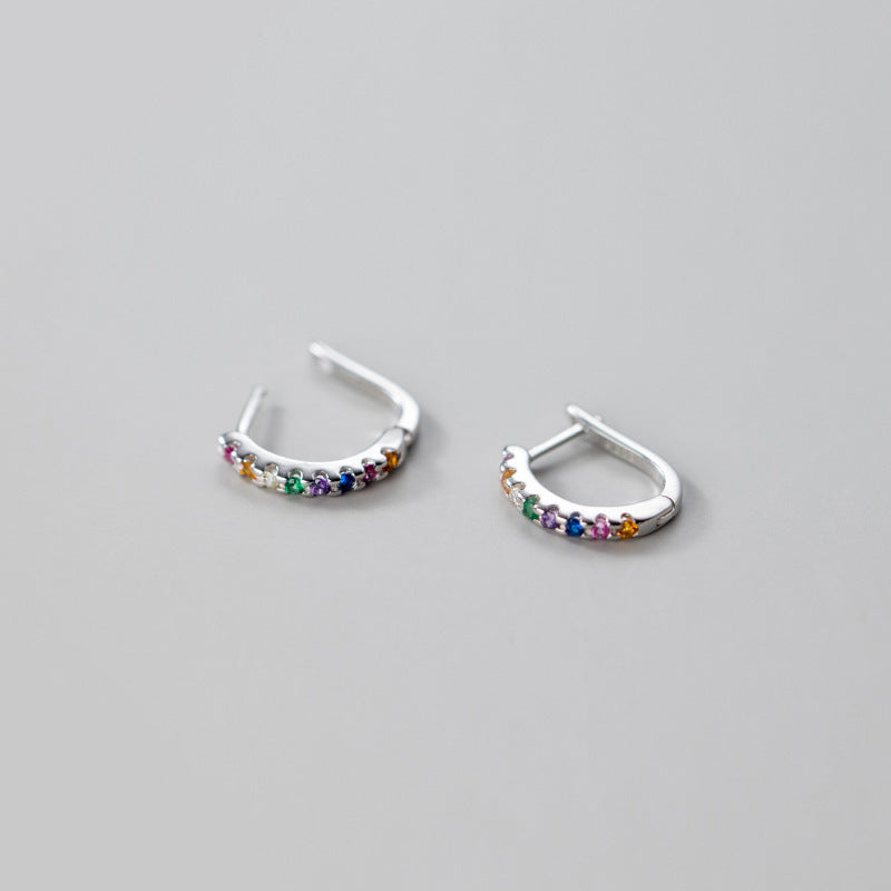 A pair of 925 sterling silver hoop huggie earrings adorned with vibrant, multicolored rainbow rhinestones, shown on a clean white background.