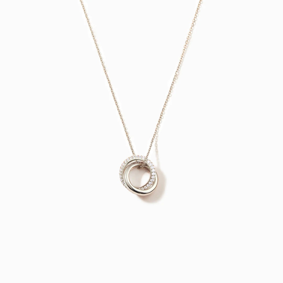 A close-up of the Eternal Circles 925 sterling silver necklace, showcasing its distinctive interlocking double-circle pendant with zircon stones.