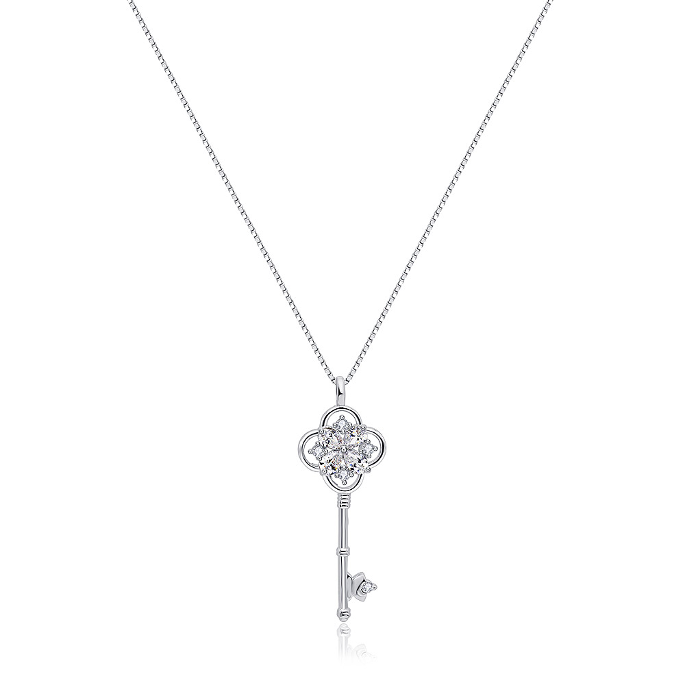 A close-up of the silver key pendant necklace, showcasing the intricate design and sparkling cubic zirconia stones set in rhodium-plated brass.