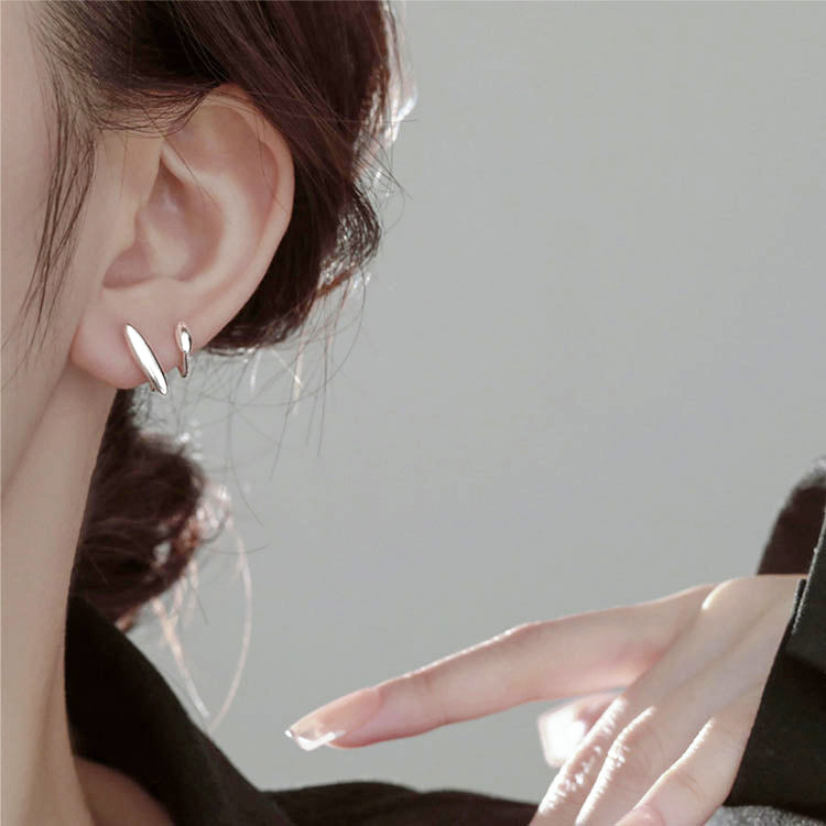 A close-up of a woman wearing a 925 sterling silver simple wrap cuff stud earring, showcasing its elegant and minimalist design.