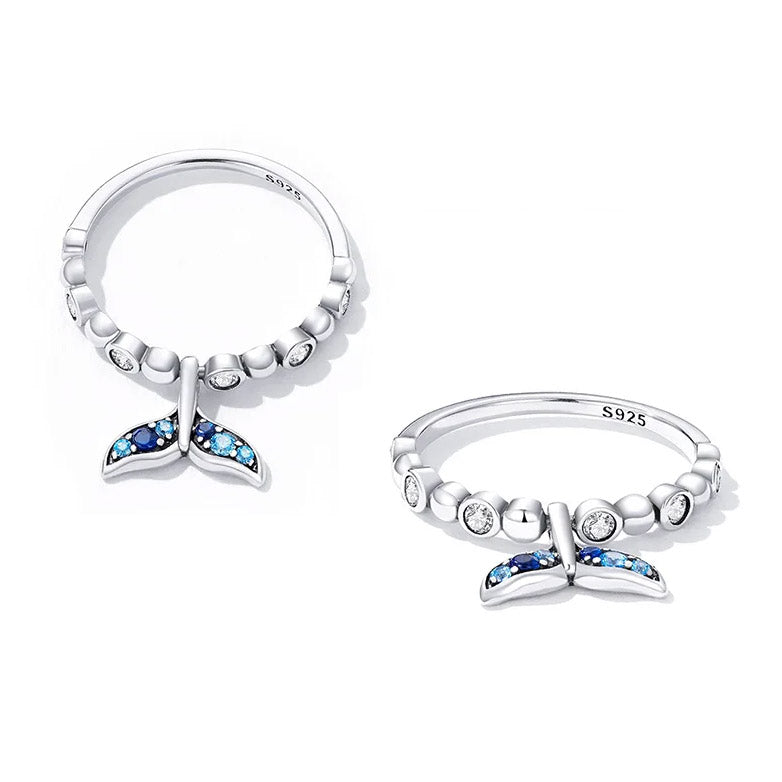 Close-up of two 925 sterling silver adjustable rings featuring a detailed mermaid tail design with sparkling blue and clear cubic zirconia stones.