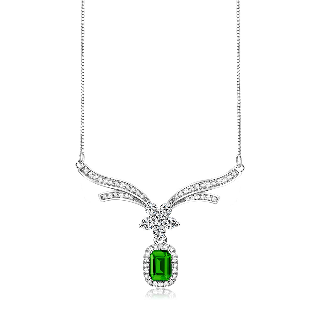 A Drop Necklace Of Elegance In Emerald, featuring a green cubic zirconia gemstone pendant with clear accents, set in rhodium-plated silver-tone metal.