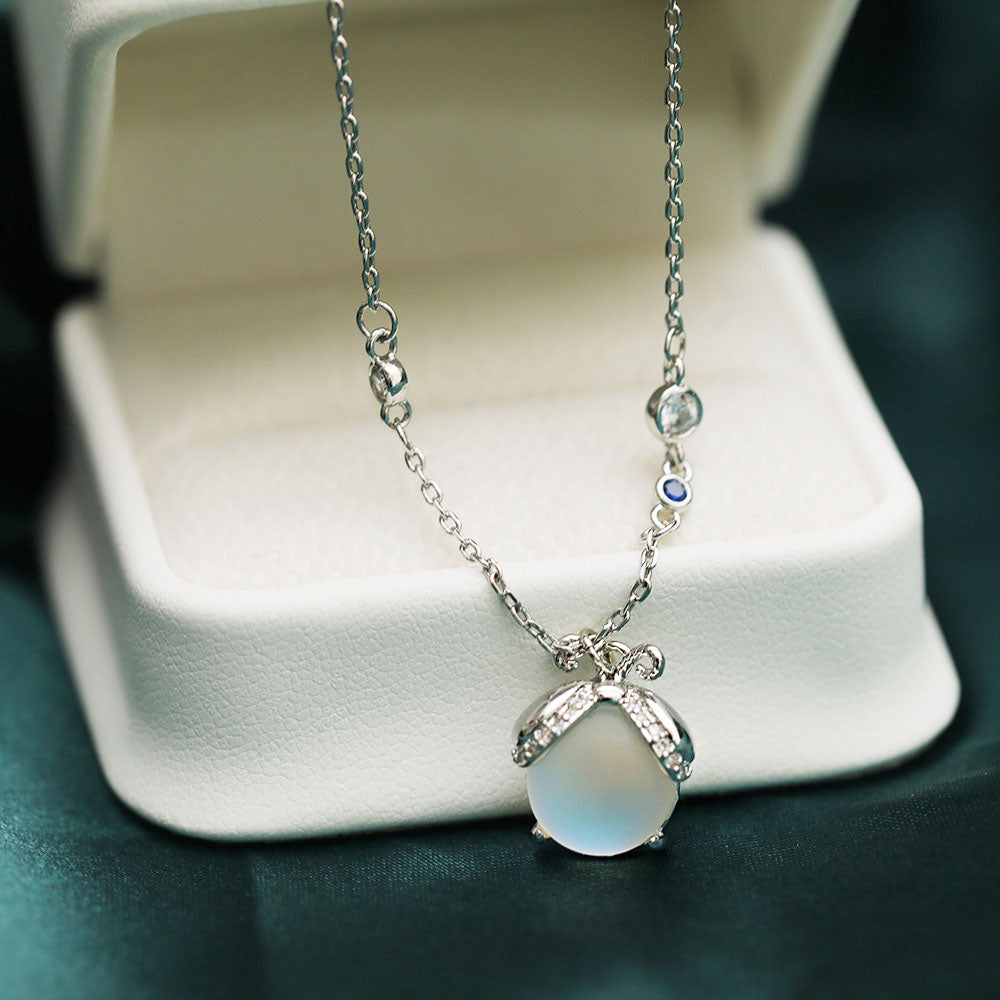 Elegant brass pendant necklace with a glowing resin firefly stone, part of a set of five.