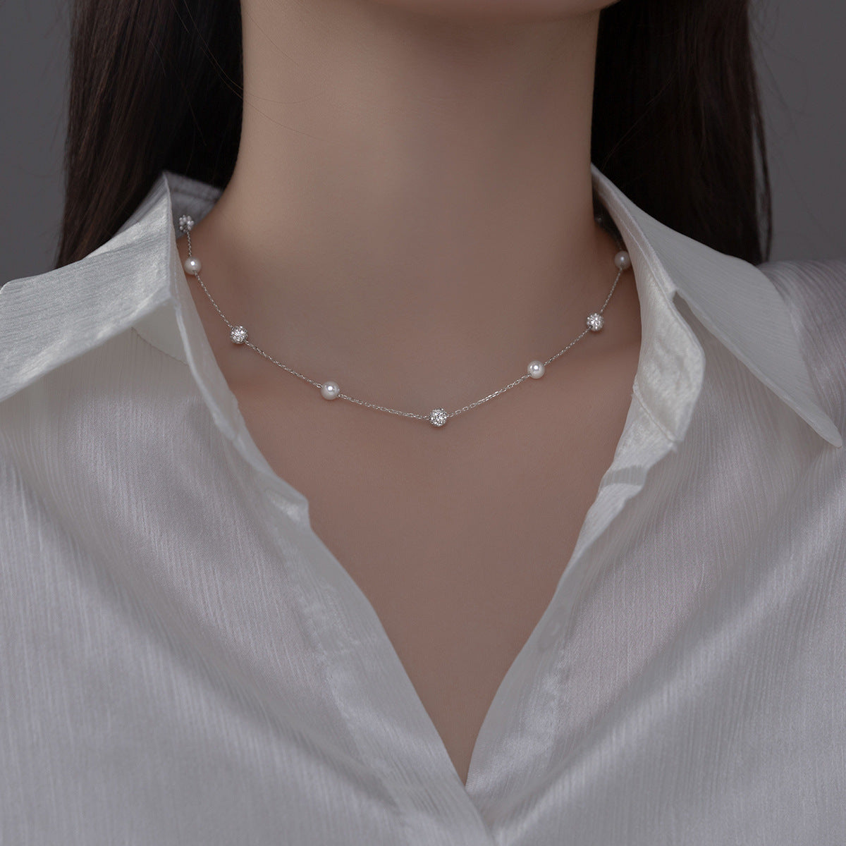 A model showcasing the elegant 925 sterling silver Y-drop choker necklace, highlighting its beautiful synthetic pearls and sparkling CZ stones.