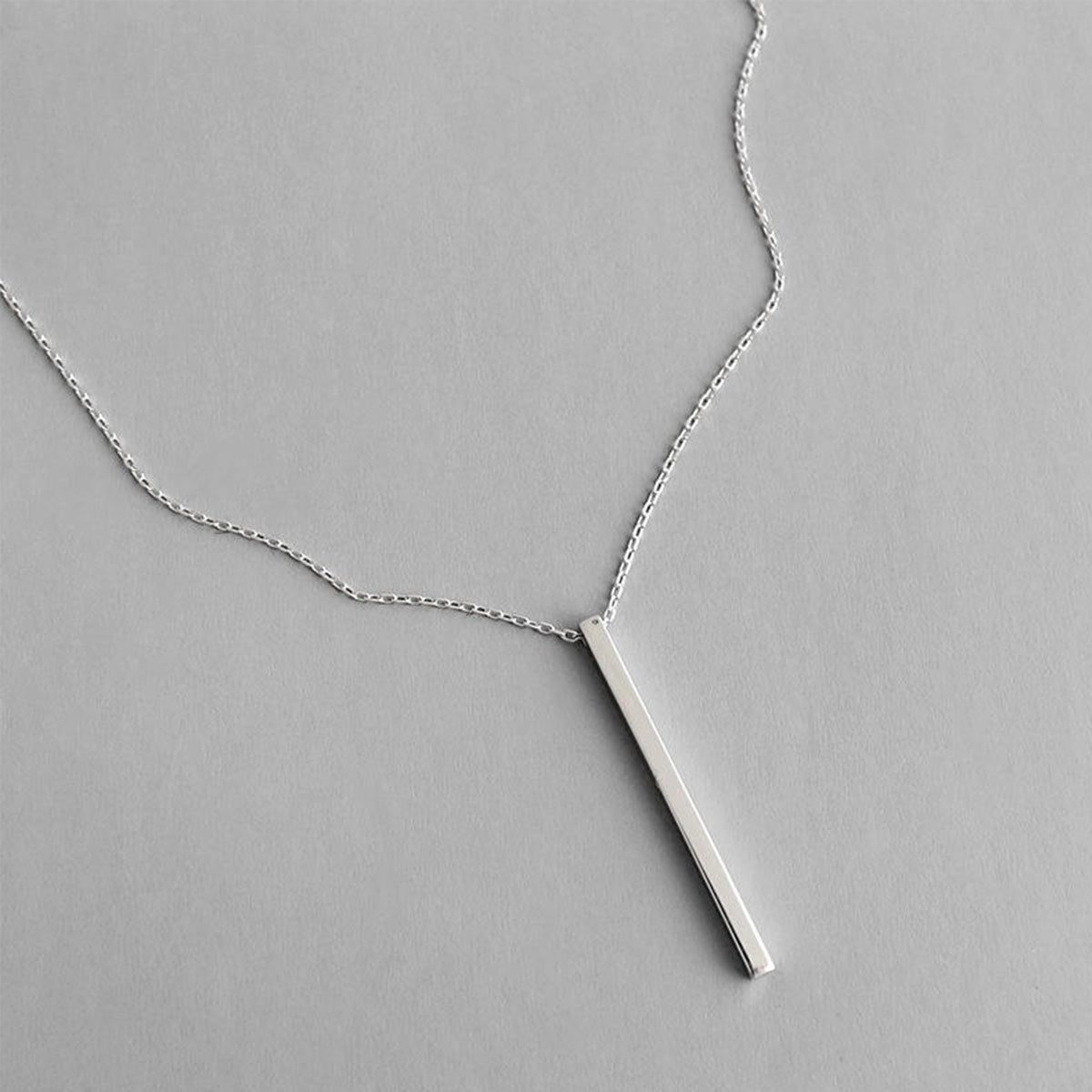 A minimalist 925 sterling silver bar pendant necklace with a sleek rectangular pendant, displayed on a neutral background.