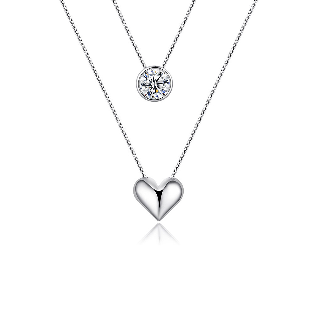 Heart Stone Layered Necklace featuring a rhodium-plated heart pendant with a clear cubic zirconia stone, displayed on a white background.