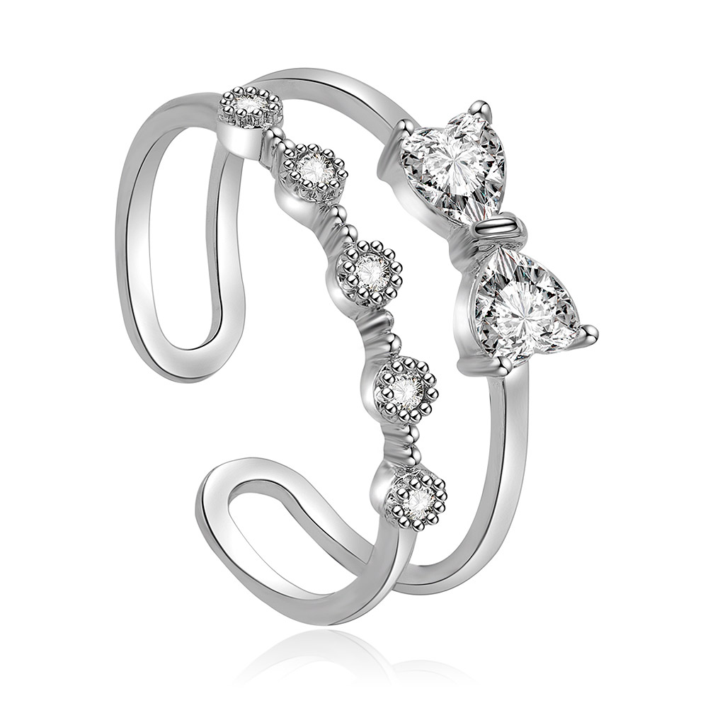 A close-up of the Love Adjustable Bow Ring, showcasing its rhodium-plated brass band and intricate bow design set with sparkling white cubic zirconia stones.