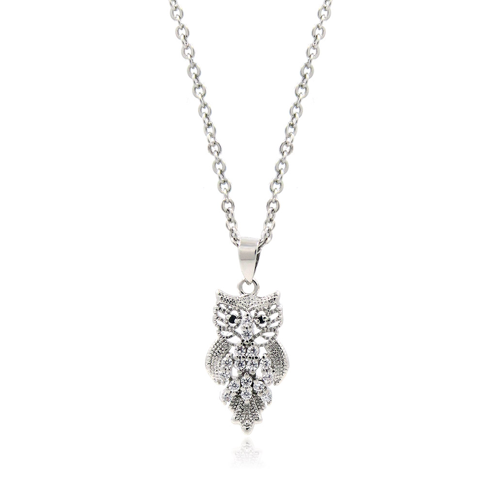 A detailed silver owl pendant necklace featuring sparkling cubic zirconia stones, set against a clean white background.