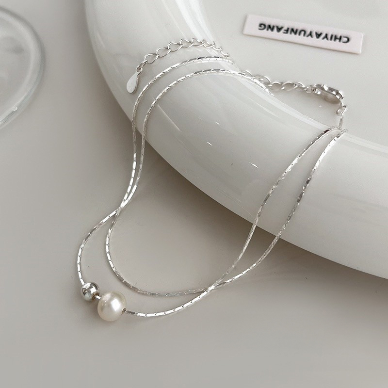 A delicate 925 sterling silver necklace with a single pearl, part of a set of 5 for elegant women.