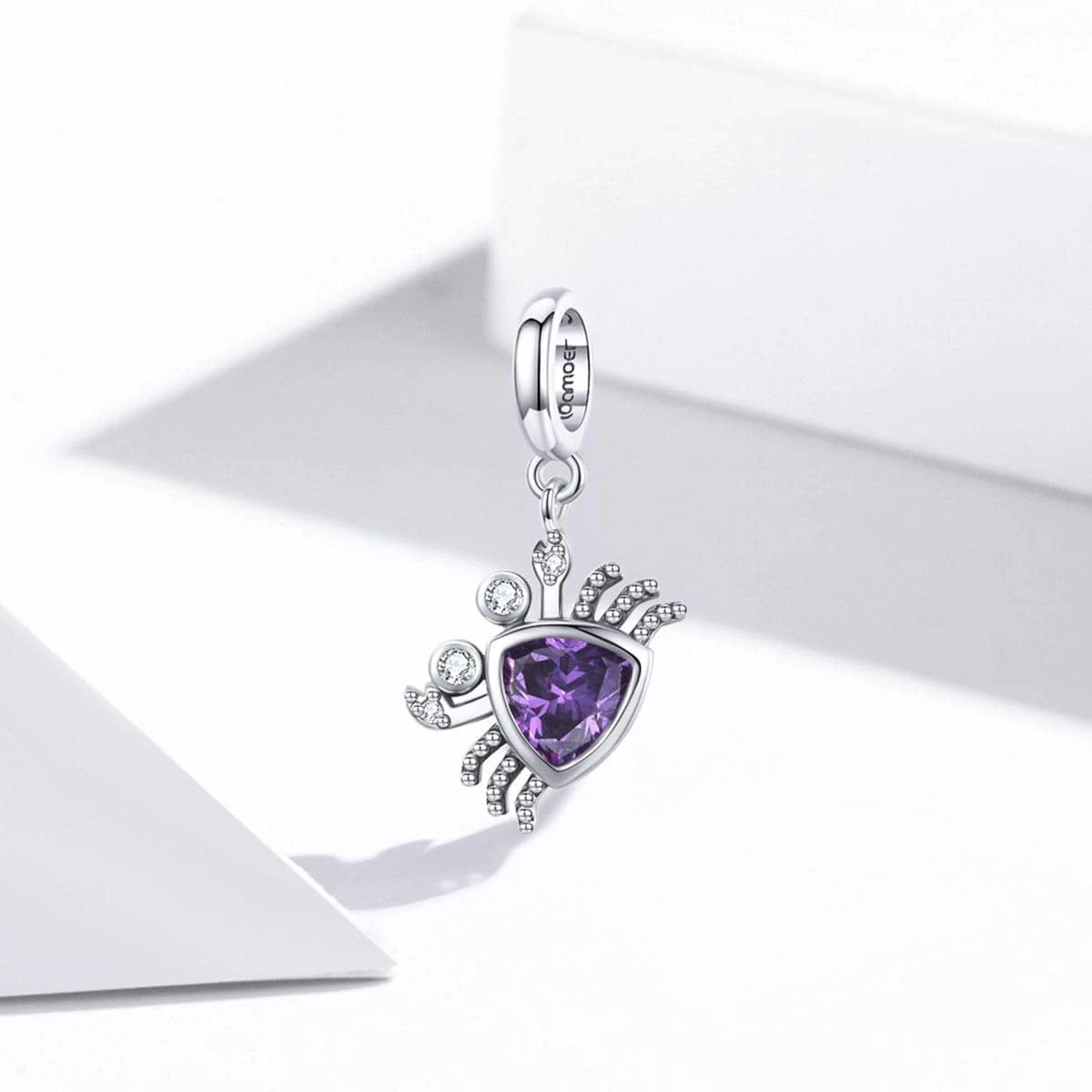 A detailed close-up of a 925 sterling silver crab-shaped charm pendant with a central purple bead, showcasing its intricate design and craftsmanship.