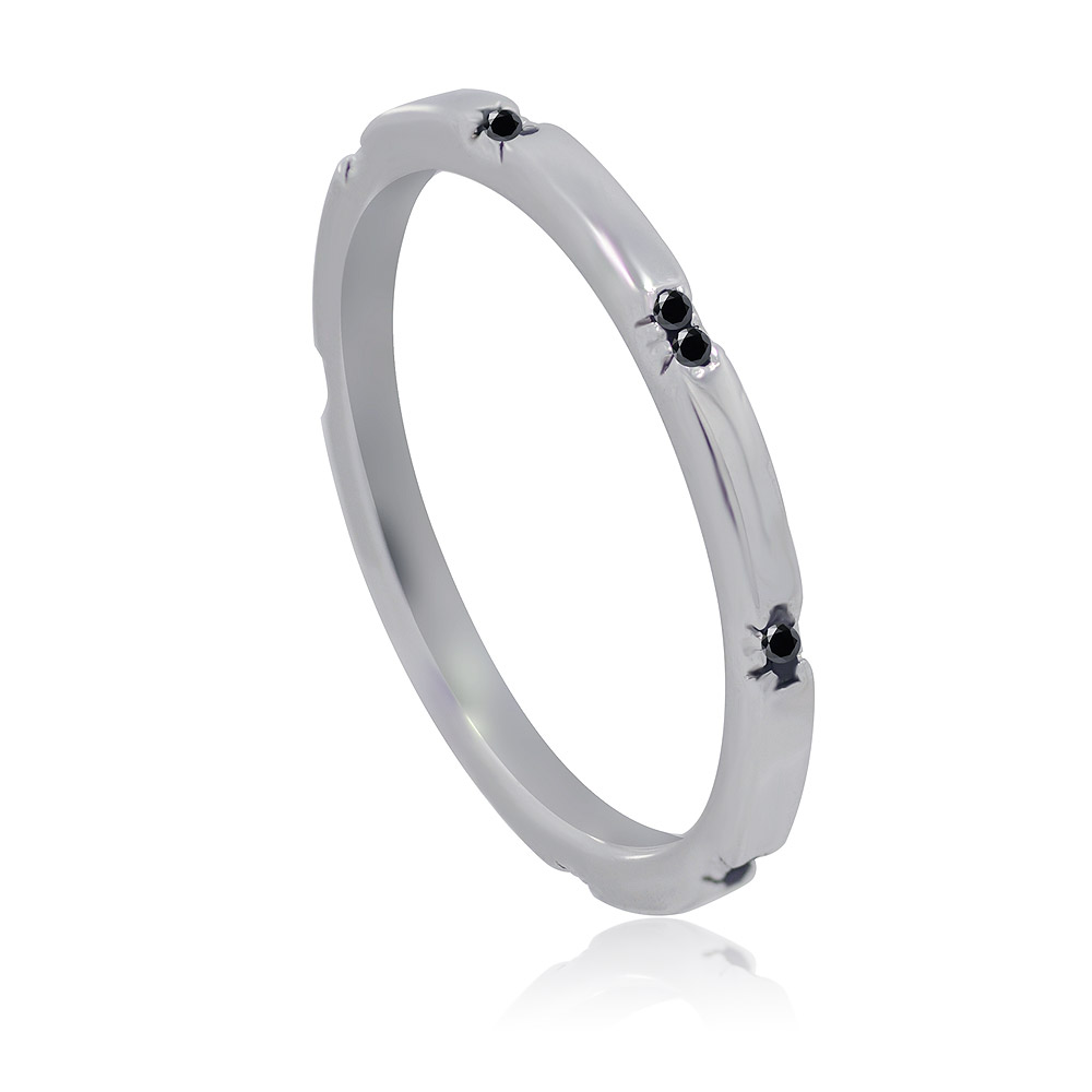 Close-up of the Black CZ Band Ring, a rhodium-plated brass ring featuring eight small black cubic zirconia stones.