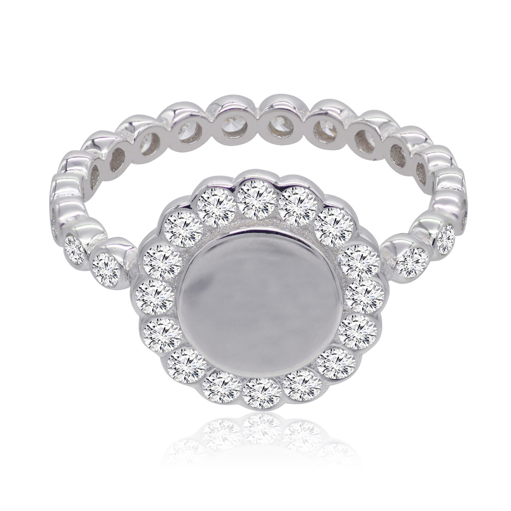 A close-up of the Floral Bezel Set Ring, showcasing its silver-colored rhodium plating and a circular centerpiece of cubic zirconia surrounded by a halo of smaller stones.