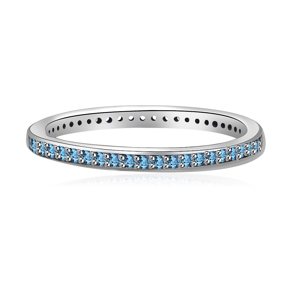 A close-up of the Aquamarine Cubic Zirconia Silver Eternity Ring, showcasing its sterling silver band and a continuous line of light blue gemstones.