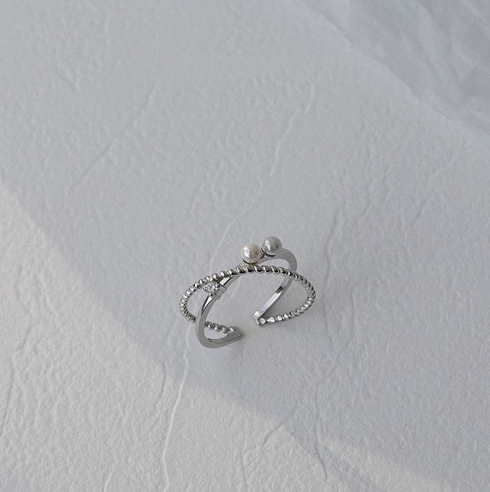 A detailed studio shot of the 925 Sterling Silver Double Layer Pearl Ring, showcasing its intricate design with a central freshwater pearl and surrounding cubic zirconia stones.