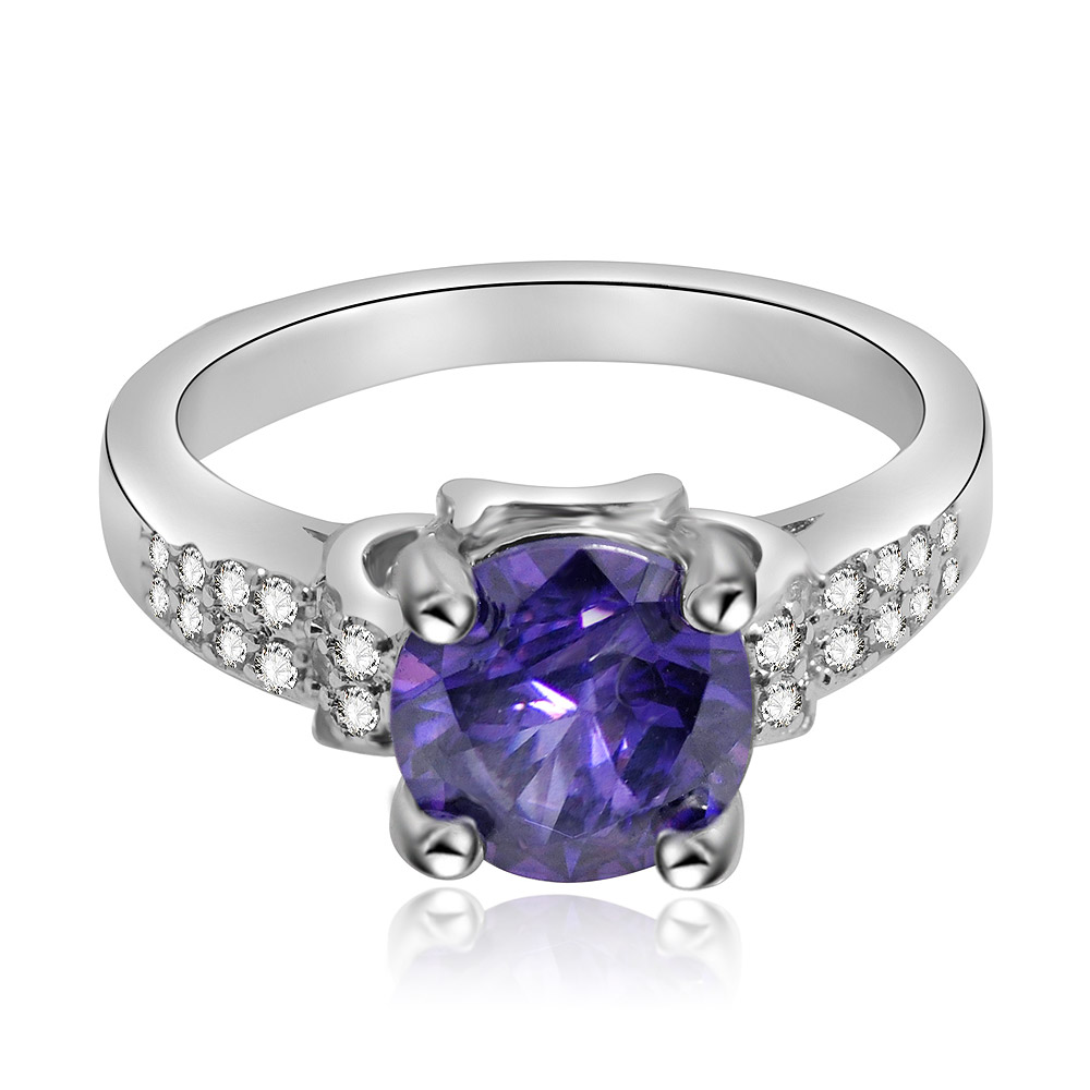 An elegant Amethyst and Cubic Zirconia Ring featuring a large purple center stone on a silver-colored, rhodium-plated band adorned with smaller white gems.