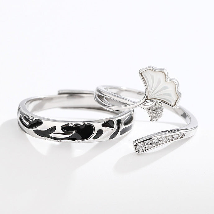 A pair of 925 sterling silver couple rings with an intricate ginkgo leaf design, symbolizing love and endurance.