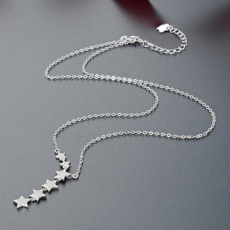 A close-up of the 925 sterling silver six shining stars tassel necklace, showcasing the detailed star pendants on a delicate chain.