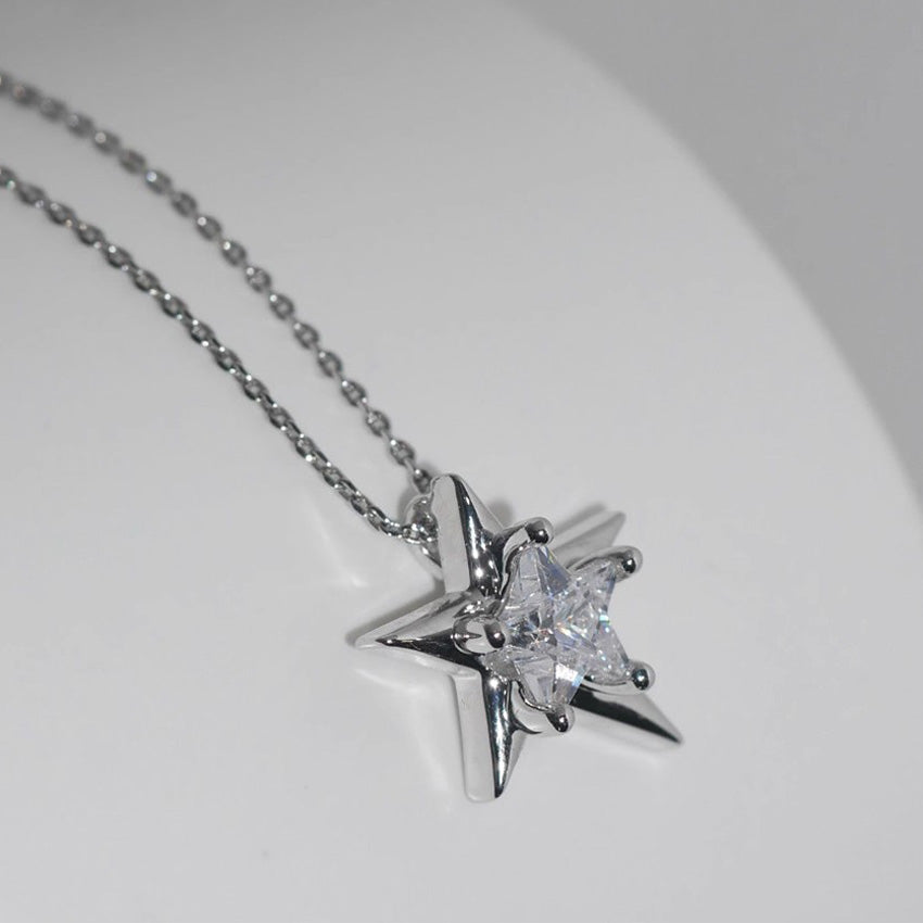 A close-up of the 925 sterling silver irregular star pendant necklace, plated with platinum and featuring a central sparkling zircon stone, on a clean white background.
